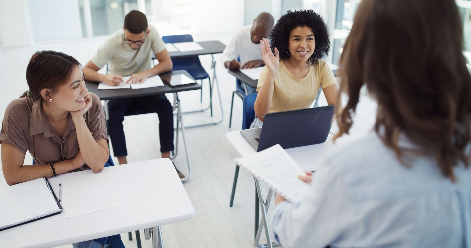 Shot of a class of university students interacting with their professor
